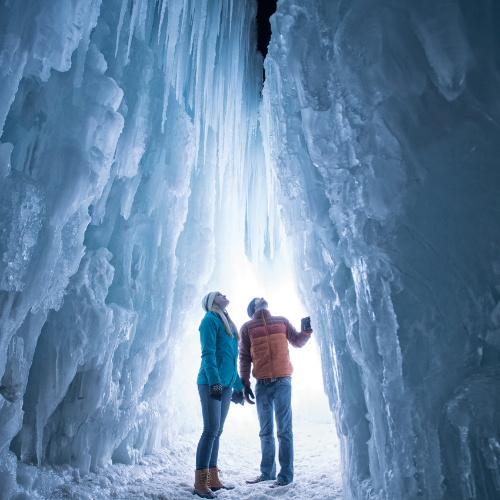 Two people looking up in an ice cave