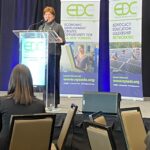 Woman speaking at a podium at NYSEDC Economic Development Conference