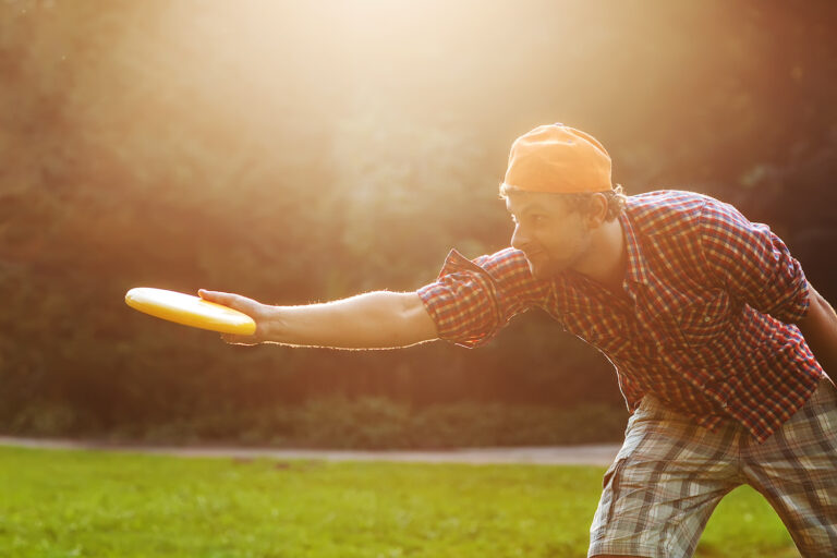 Man playing frisbee disc golf in the park