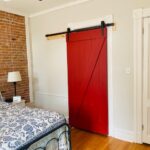 Red barn sliding door in bedroom