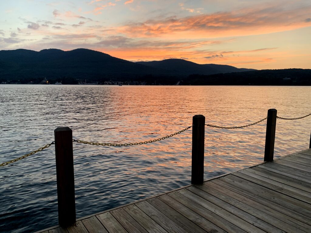 Sunset view of Lake George with dock in the foreground