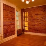empty room with brick walls and white trim