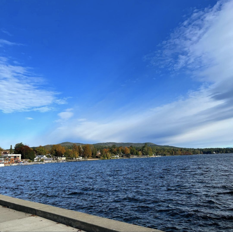 View of the lake from the sidewalk on a sunny fall day.