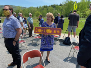 Betty Little holding her road sign
